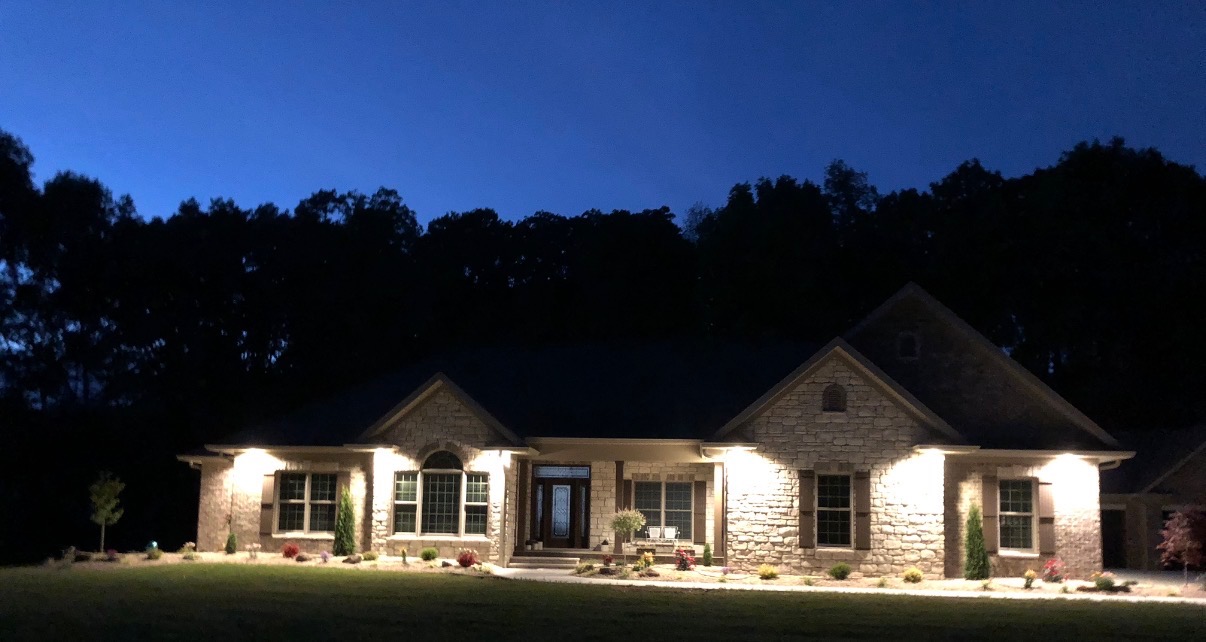 Landscape lighting along a walkway at dusk at a Southern Indiana home