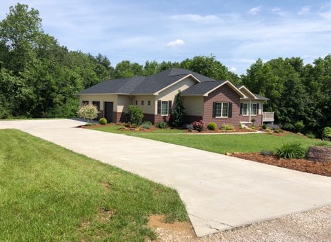 New construction landscape with cleared lot, lawn and fresh beds